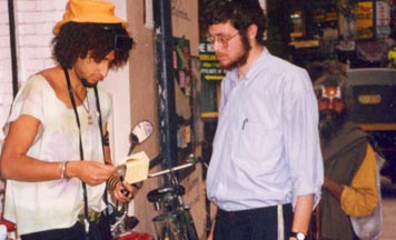 Chabad student on the streets of Katmandu assists a tourist with putting on tefillin